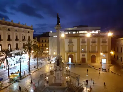 a city square at night with a statue in the middle at Palazzo Edy&Stef 1 in Palermo