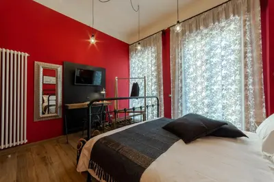 a bedroom with red walls and a bed and a window at il Palchetto B&B di Charme e Design in Palermo