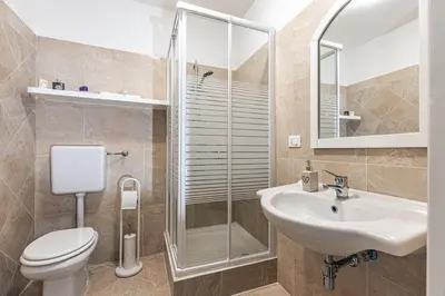 a bathroom with a toilet and a sink and a shower at Giulio Cesare 14, Residence in Palermo