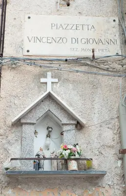 a church with a cross on the side of a building at La maison à la cathedral in Palermo