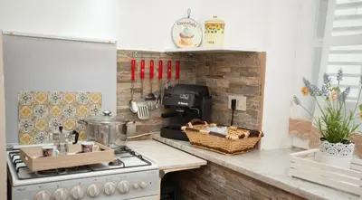 a kitchen with a stove and a counter top at La maison à la cathedral in Palermo