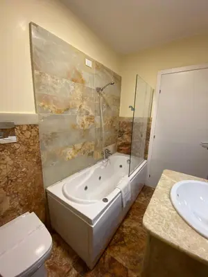 a bathroom with a tub and a toilet and a sink at 55 Aira Hotel in Palermo