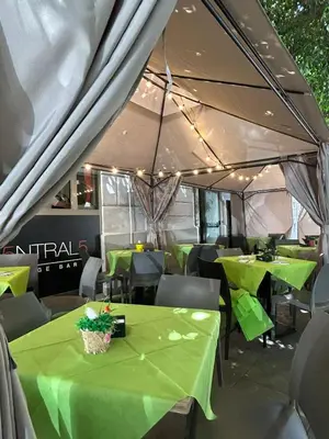 a tent with green tables and chairs in a restaurant at 55 Aira Hotel in Palermo