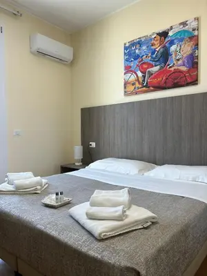 a bedroom with a bed with towels on it at 55 Aira Hotel in Palermo