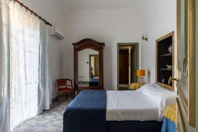 a bedroom with a bed and a mirror at Ajutamicristo Domus by DomuSicily in Palermo