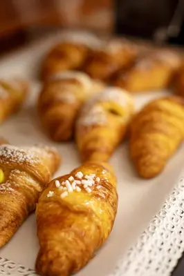 a bunch of pastries sitting on a white plate at Hotel Sabbia d'Oro in San Vito lo Capo