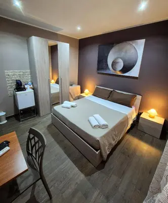 a bedroom with a bed with two towels on it at B&B Rampante in Piana degli Albanesi