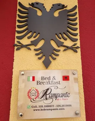 a sign for a bed and breakfast with an eagle on it at B&B Rampante in Piana degli Albanesi
