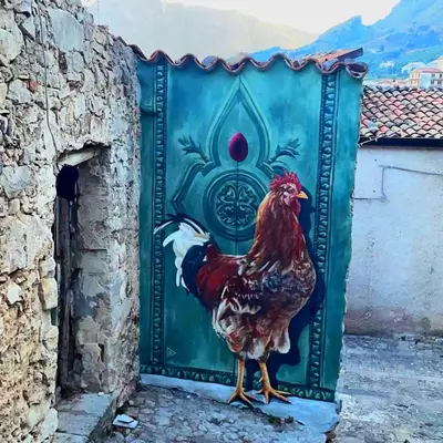 a door with a rooster painted on it at B&B Rampante in Piana degli Albanesi