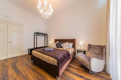 a bedroom with a bed and a chair at Palazzo Ardizzone in Palermo