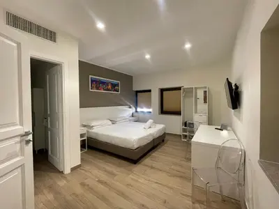 a bedroom with a bed and a tv in it at B&B Ruggero Settimo - Room & Suite in Palermo