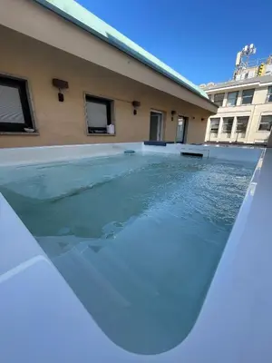 a swimming pool in the middle of a building at B&B Ruggero Settimo - Room & Suite in Palermo