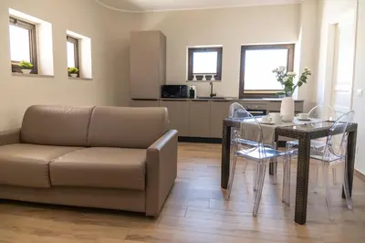 a living room with a couch and a table at B&B Ruggero Settimo - Room & Suite in Palermo