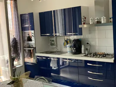 a kitchen with blue cabinets and a counter top at Casa Casteldaccia 2 in Casteldaccia