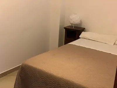 a bedroom with a bed and a lamp on a table at Casa Casteldaccia 2 in Casteldaccia