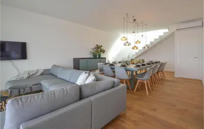 a living room with a couch and a table with chairs at Stunning Home In Balestrate in Balestrate