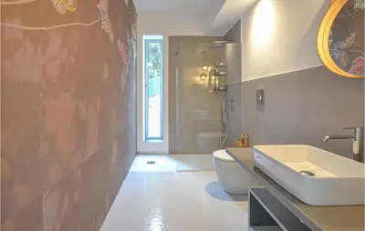 a bathroom with a white sink and a toilet at Stunning Home In Balestrate in Balestrate