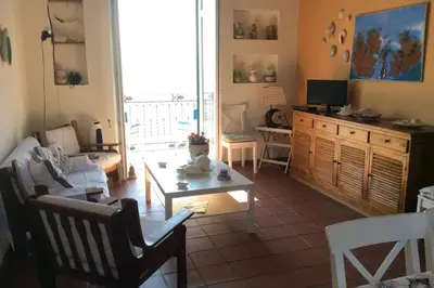 a living room with a couch and a table at Casa nel borgo marinaro di Santa Nicolicchia in Santa Flavia