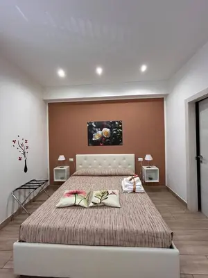 a bedroom with a large bed with two pillows on it at A Casa di Josephine in Palermo