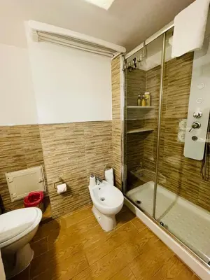 a bathroom with a toilet and a shower and a sink at Duba House Holiday Home in Palermo