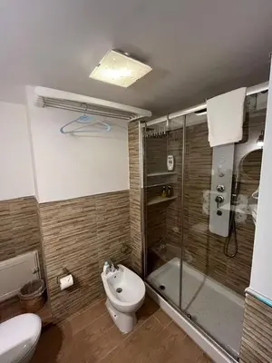 a building with a brown door and two scooters parked outside at Duba House Holiday Home in Palermo