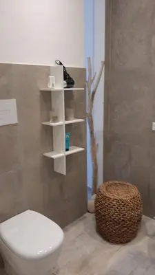 a bathroom with a white toilet and a stool at stella di ponente in Macari