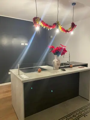 a counter with a vase with flowers on it at Piazza Florio Rooms in Palermo