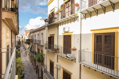 an alley in an old town with balconies at Magione Apartment with Terrace by Wonderful Italy in Palermo