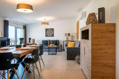 a dining room and living room with a table and chairs at Villa Mendez in Castellammare del Golfo