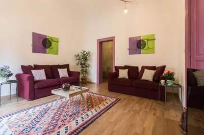 a living room with two purple couches and a rug at Large apartment near Politeama 2 bathrooms Up to 8 Guests in Palermo