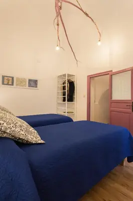 a bedroom with a blue bed and a mirror at Large apartment near Politeama 2 bathrooms Up to 8 Guests in Palermo