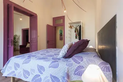 a bedroom with a blue and white bed with pillows at Large apartment near Politeama 2 bathrooms Up to 8 Guests in Palermo