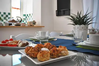 a table with two plates of pastries on it at Villa la Rina in Palermo