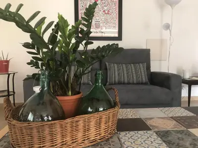 two wine bottles in a basket on a table in a living room at Villa la Rina in Palermo