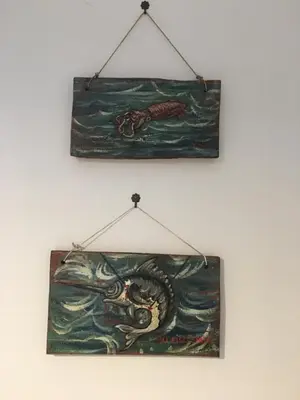 a painting is hanging on a wall at Dost in Palermo