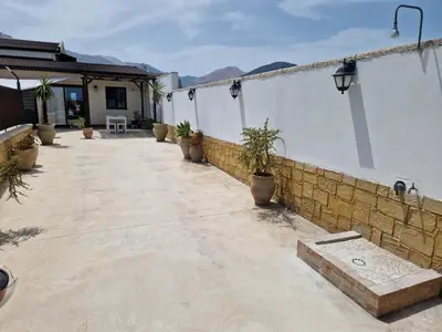a patio with potted plants on the side of a building at Kalimera in Capaci