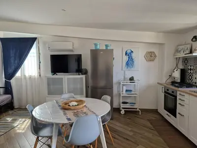a kitchen with a table and chairs in a room at Kalimera in Capaci