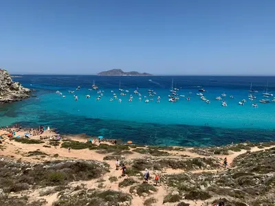 a group of boats in the water at a beach at casa Cuffa in San Vito lo Capo