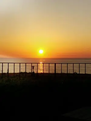 a sunset over the ocean with a fence at casa Cuffa in San Vito lo Capo