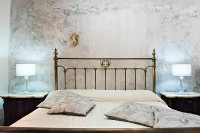 a bedroom with a bed with two lamps on tables at Villa Blondie con piscina a Castellammare del Golfo in Castellammare del Golfo