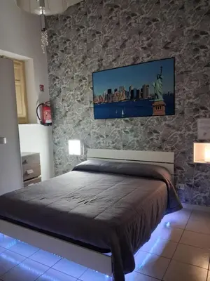 a bedroom with a bed with a tv on the wall at Monfenera Apartment 2 in Palermo