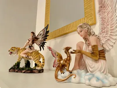 three figurines of a woman and tigers on a shelf at Monfenera Apartment 2 in Palermo