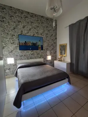 a bedroom with a large bed with blue lights at Monfenera Apartment 2 in Palermo
