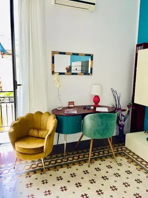 a living room with a desk and a chair at Funky flat in Palermo