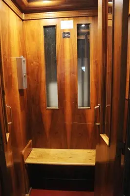 a wooden door with two windows on a train at Funky flat in Palermo