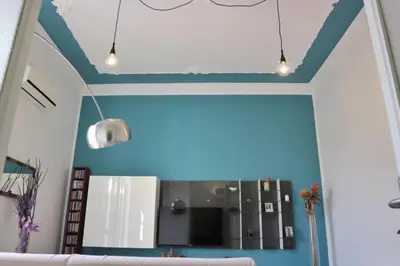 a living room with blue walls and a couch at Funky flat in Palermo