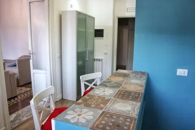 a room with a table and chairs and a blue wall at Funky flat in Palermo