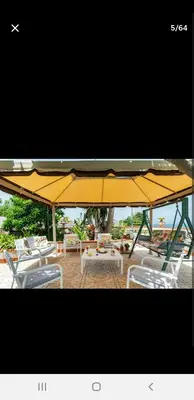 a yellow umbrella and some chairs and a table at Villa Teresa in Trappeto