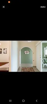 two pictures of a room with a bed and a room with a wall at Villa Teresa in Trappeto