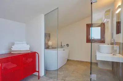 a bathroom with a glass shower and a sink at Villa della Pigna in Scopello